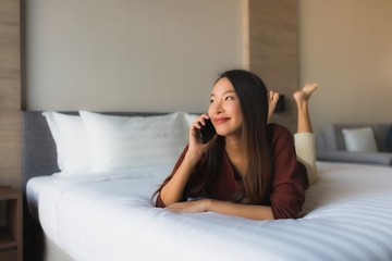 Portrait beautiful young asian women using mobile phone on bed