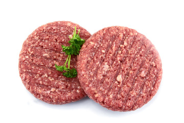 two minced steaks of raw beef on a white background