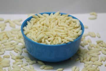 Puffed rice on the blue bowl with white background