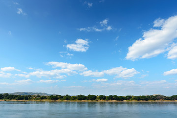 The image is for the background, light blue sky and clouds with a slight reflection of the river.