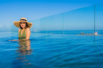 Beautiful young asian women happy smile relax around outdoor swimming pool in hotel resort for travel in holiday vacation