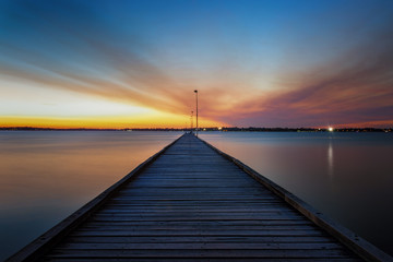 Fototapeta na wymiar Diminishing perspective sunset, long exposure, at pier in Perth Australia