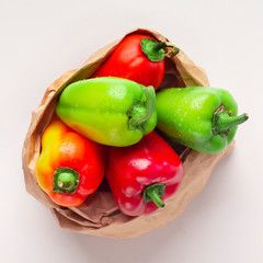 Eco friendly paper bag with organic paprika on white