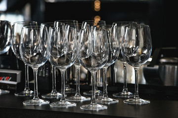 Glasses for a margarita, martini, grog and liqueur on a bar at restaurant, against the bar bar wall...