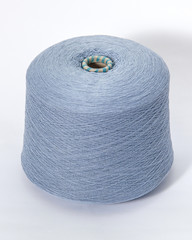 Green bobbin of yarn on a white background.Textile reel on isolated white background.