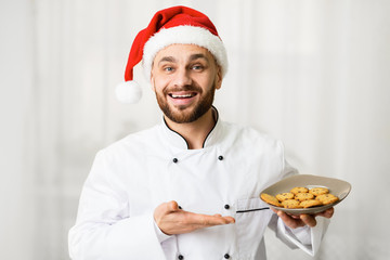 Baker Man Holding Plate With Christmas Cookies Over White Background