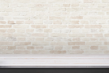 Empty wooden desk with brick wall in background. Space for product promotion
