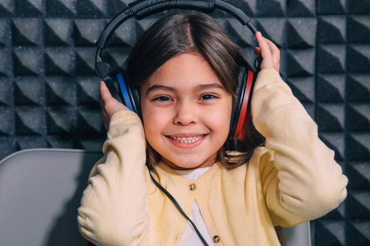 Cute Little Mixed Race Child While Procedure Hearing Exam. Girl Wearing Special Headphones Getting Hearing Test, Audiometry