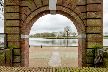 Maaspoort, City gate at the fortified city Grave in the Netherlands, view through the gate over river meuse