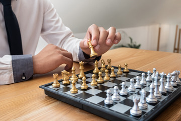 hand of businessman moving chess in competition, shows leadership, followers and business success strategies