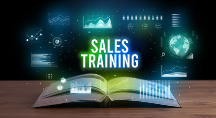 SALES TRAINING inscription coming out from an open book, creative business concept