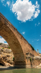 Panoramic view of the Severan Bridge, Cendere Koprusu is a late Roman bridge, close to Nemrut Dagi and Adiyaman, Turkey. Roadway flanked by ancient columns of Roman Emperor Lucius Septimius Severus
