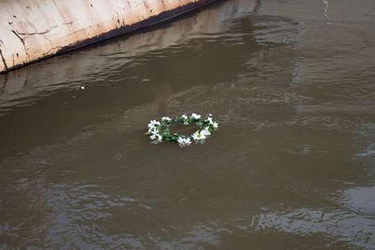 handmade wedding wreath floats on the river