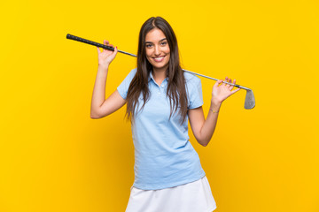Young golfer woman over isolated yellow wall