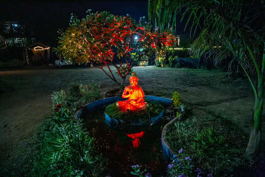 Beautiful Buddha statue in the night garden, Goa, India