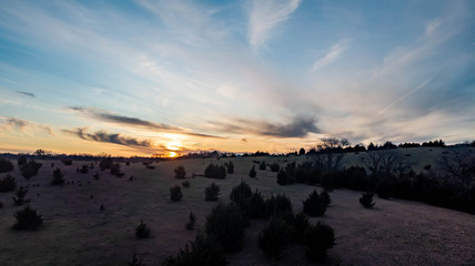 Sunset over a rural countryside landscape and high clouds