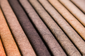 Colorful and bright fabric samples of furniture and clothing upholstery. Close-up of a palette of textile abstract stripes of different colors