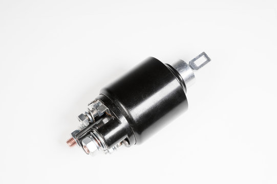 New black solenoid for a starter for a car on a gray gradient background. Auto parts. Starter Parts