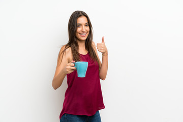 Young woman over isolated white background holding hot cup of coffee