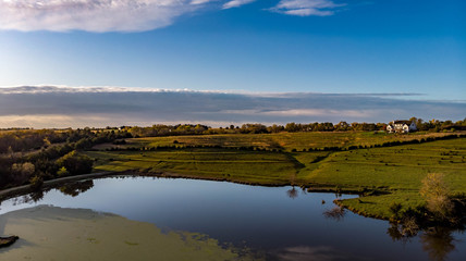 Morning over a rural countryside pond in Nebraska during autumn