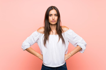 Young woman over isolated pink background angry
