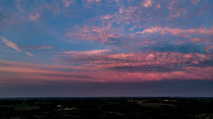 Beautiful sunset and clouds over the rural countryside homes and farms in Nebraska