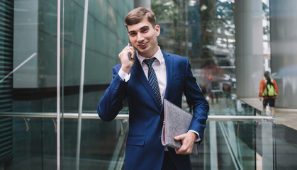 Entrepreneur in suit smiling talking on phone