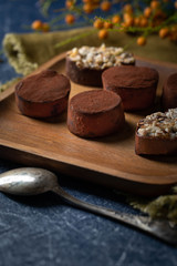Obraz na płótnie Canvas chocolate truffles on a wooden plate