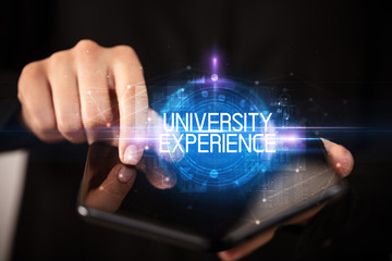 Young man holding a foldable smartphone with UNIVERSITY EXPERIENCE inscription, educational concept