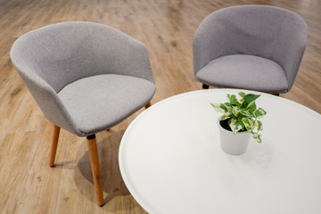 Grey armchair with white round table