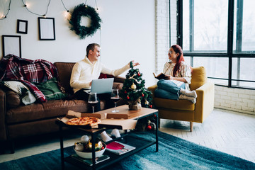 Content woman and man chatting in cozy living room