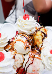 Ice cream scoops with cherry and whipped cream