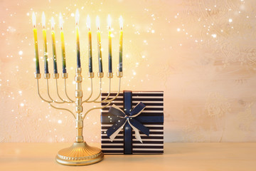 Religion image of jewish holiday Hanukkah background with brass menorah (traditional candelabra) and candles