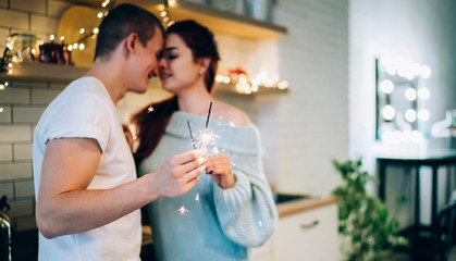 Loving couple with sparkles on Christmas time