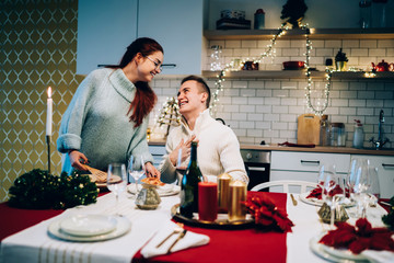Girlfriend serving pizza to grateful boyfriend on Christmas