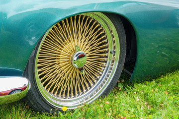 Gold colored spoke rims at a car