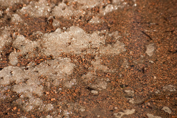 Sand covered with melted snow
