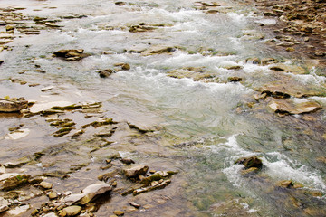 Beautiful Reshi River water flowing through stones and rocks at dawn,