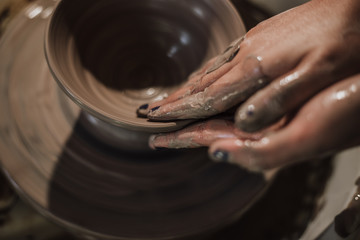 Hands of craftsman artist working on pottery wheel.Selective Focus .