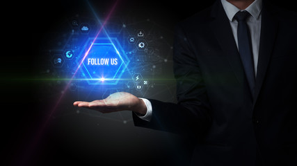Man hand holding FOLLOW US inscription, social media concept