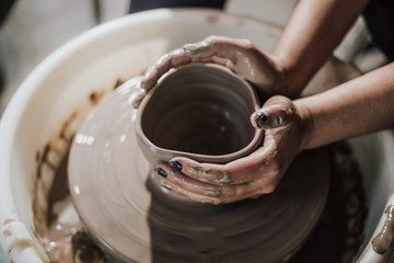Fototapeta na wymiar Hands of craftsman artist working on pottery wheel.Selective Focus .