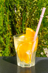 glass of orange juice on background of blue sky