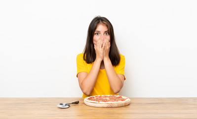 Caucasian girl with a pizza with surprise facial expression