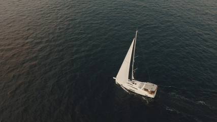 Aerial View of yacht in ocean. Drone footage of yachting around Balearic islands in the...