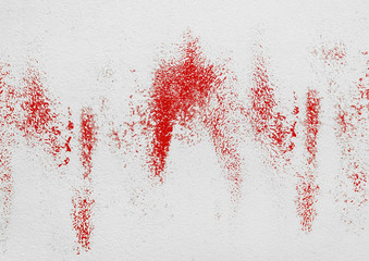 Traces, spots of red paint on a white wall or blood