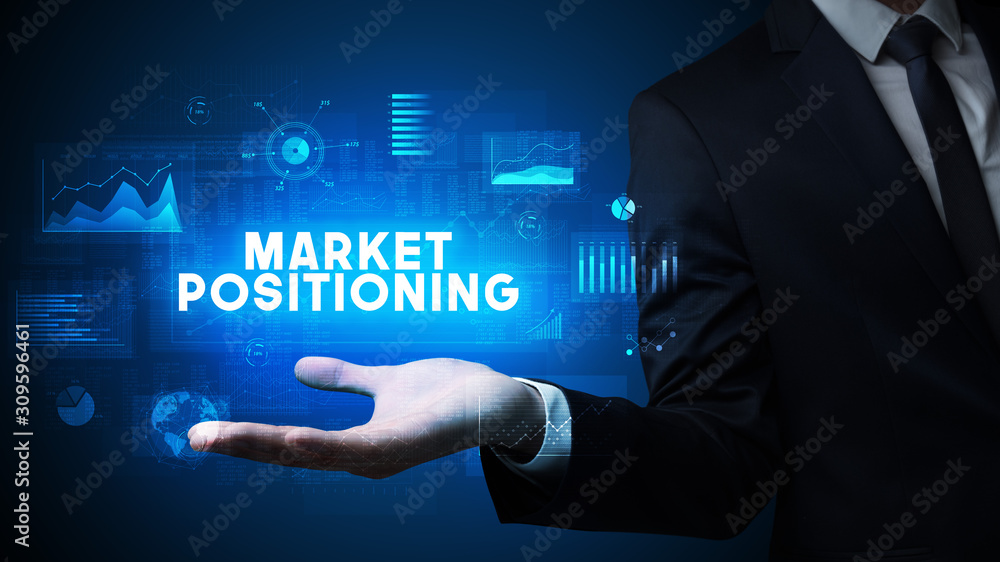 Wall mural hand of businessman holding market positioning inscription, business success concept