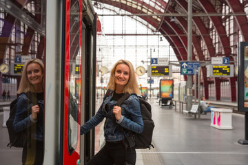 Female tourist enters the train on railway station