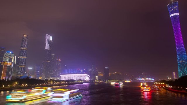 Guangzhou motorboats on night Pearl river in China timelapse zoom out