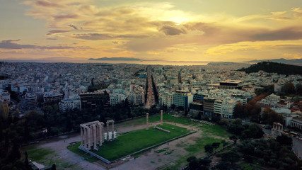 Aerial drone photo of iconic ruins of Temple of Zeus in Athens historic centre at dusk with beautiful sky and colours and Syggrou avenue at the background, Attica, Greece