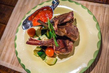 Delicious braised beef ribs with vegetables on the plate